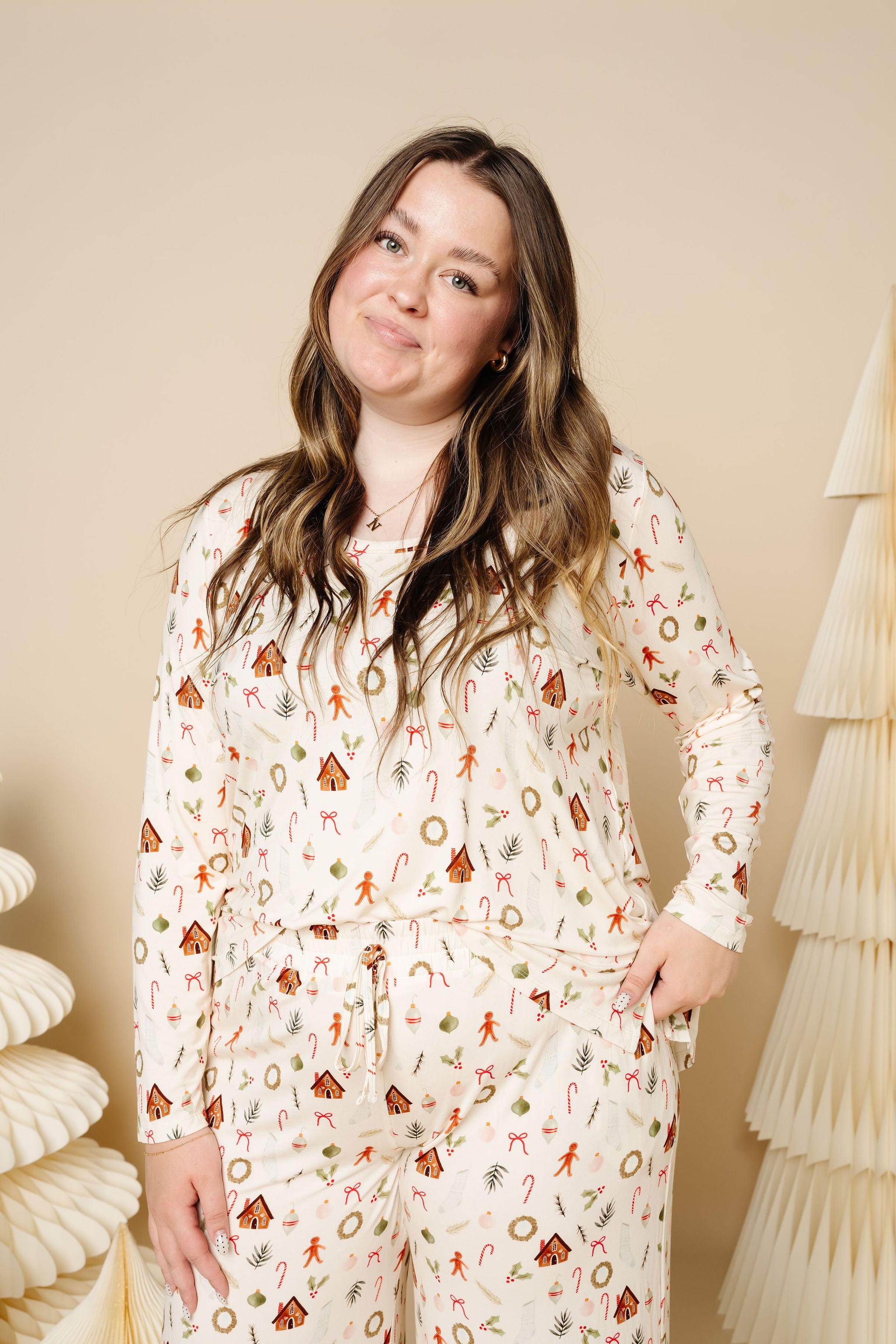 Woman wearing a patterned pajama set against a neutral background