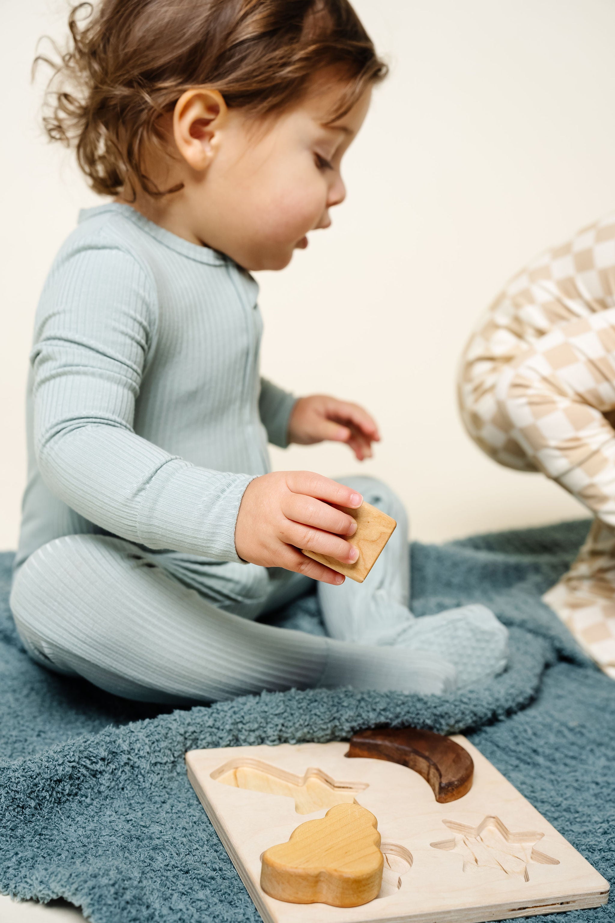 Bailey Zipper Footies Toddler Boy 12-24 Month Size sitting on blanket playing with toys