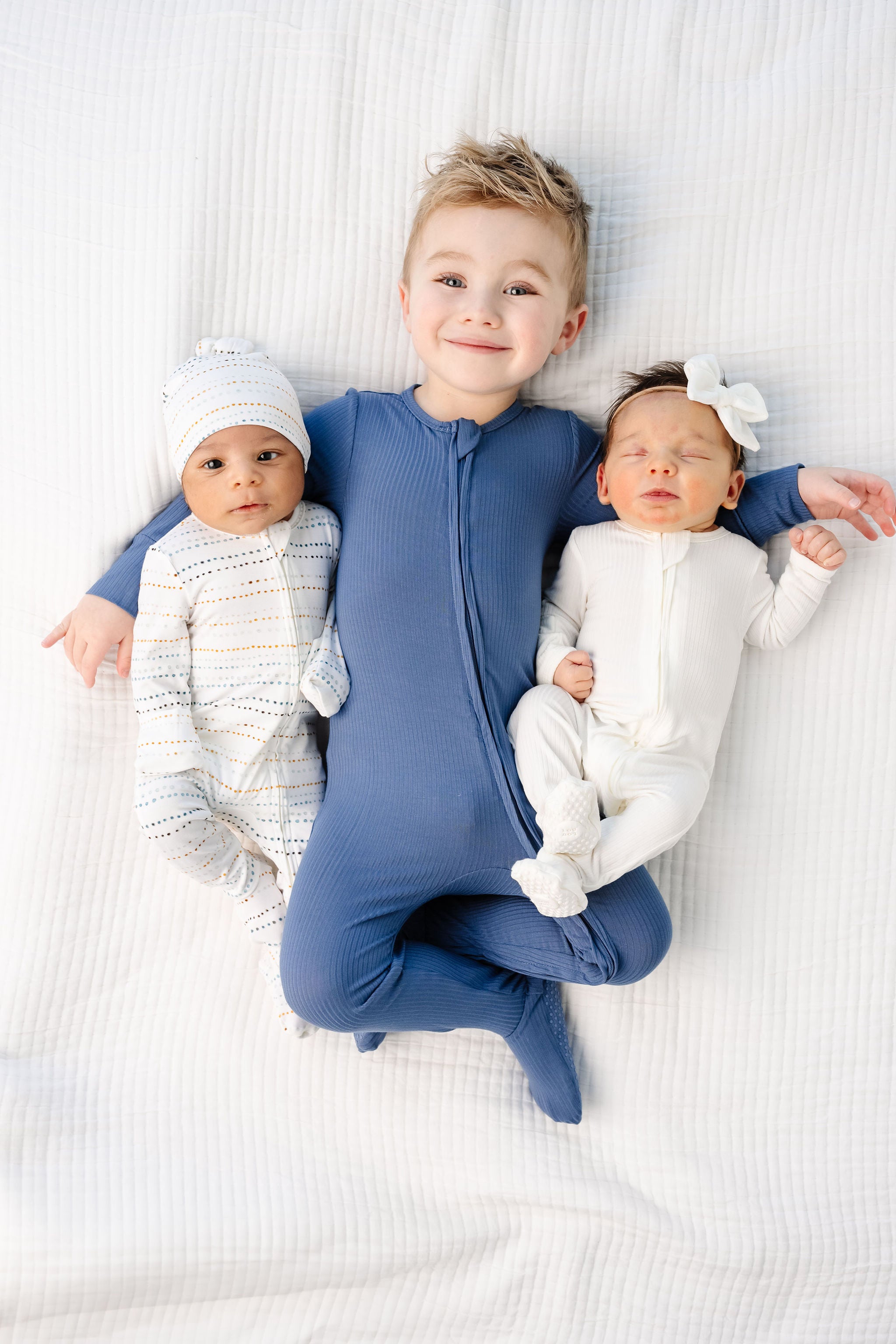 Harrison Zipper Footies toddler boy wearing 2T size with baby boy in conrad zipper footies and baby girl in wren zipper footies