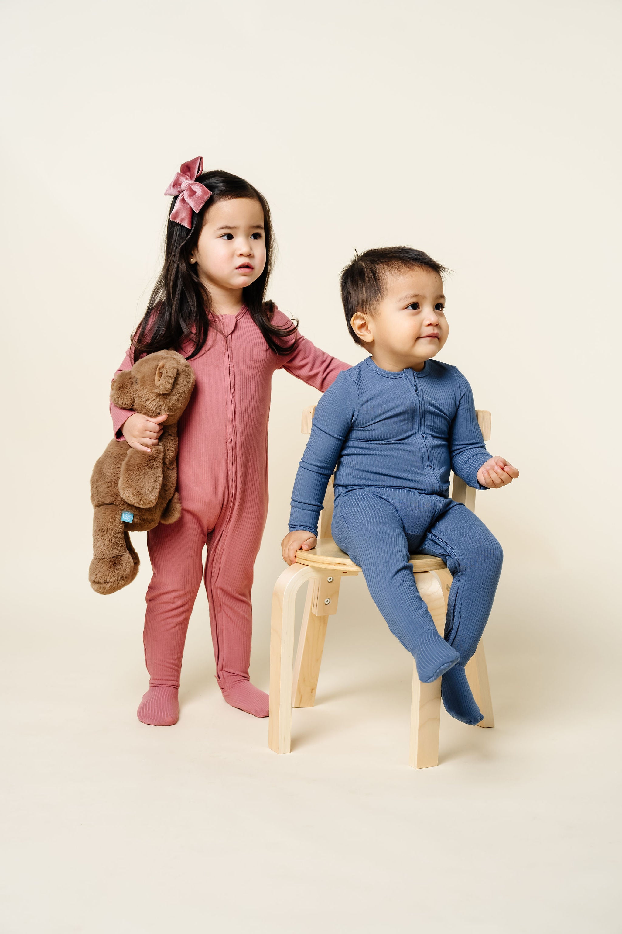 Marjorie Zipper Footies Harrison Zipper Footies toddler girl standing toddler boy sitting in chair