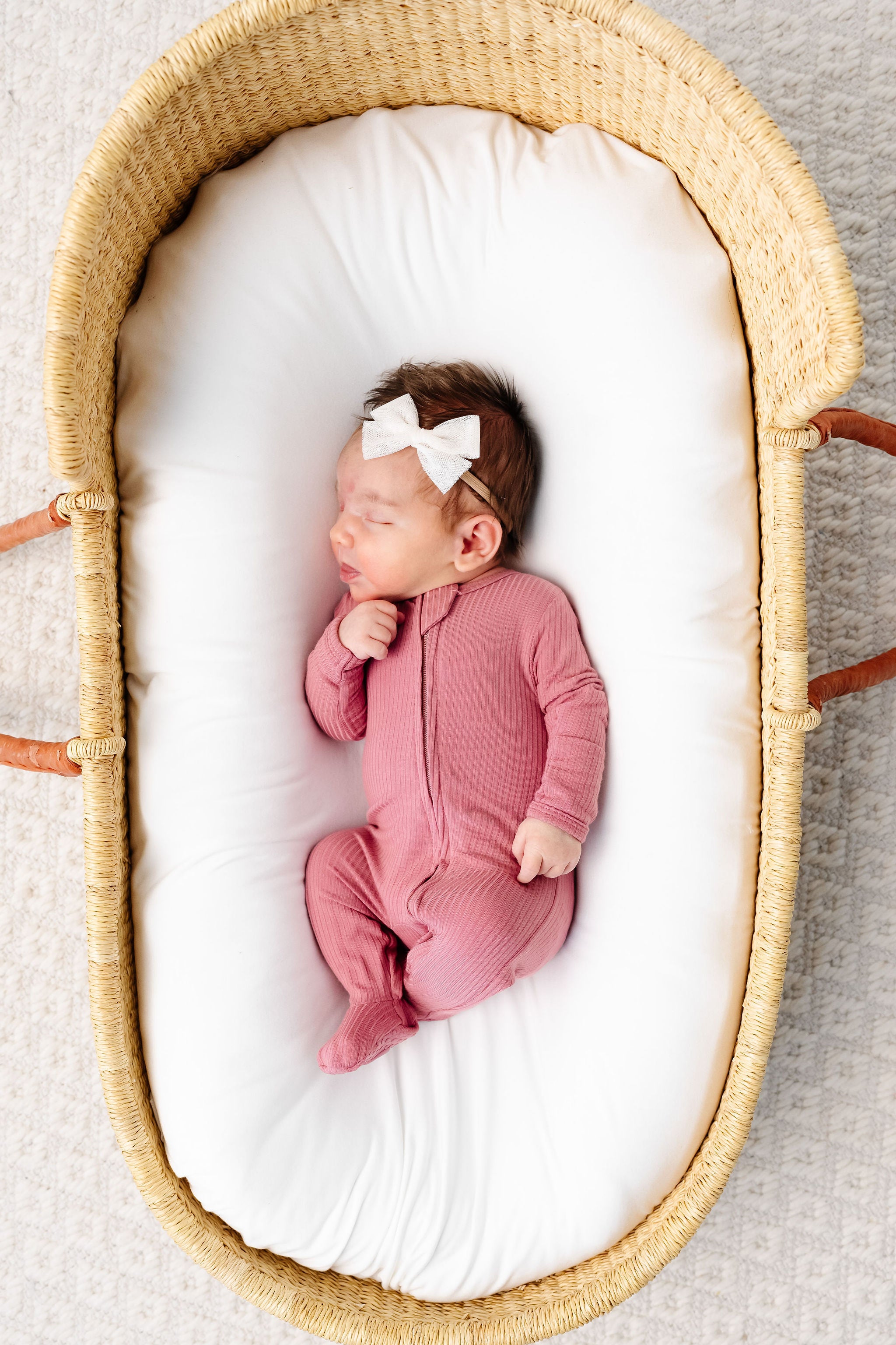 Marjorie Zipper Footies Newborn Girl in newborn size in bassinet