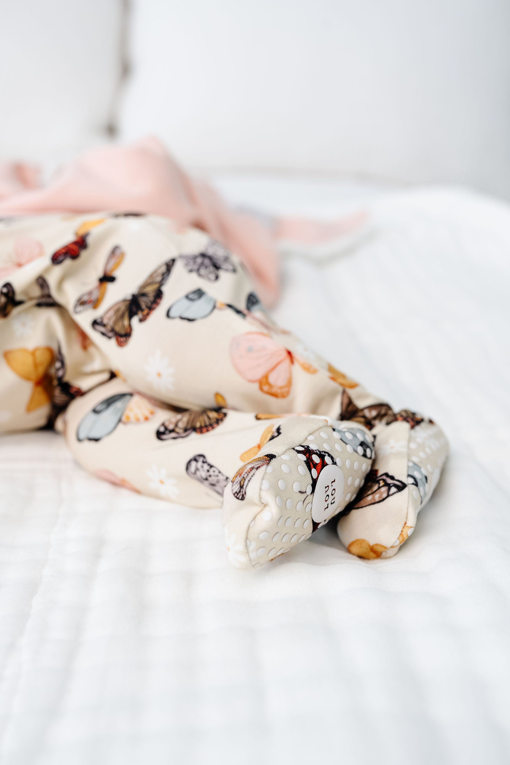 amelia zipper footies zoom in on footie girl newborn girl laying on bed