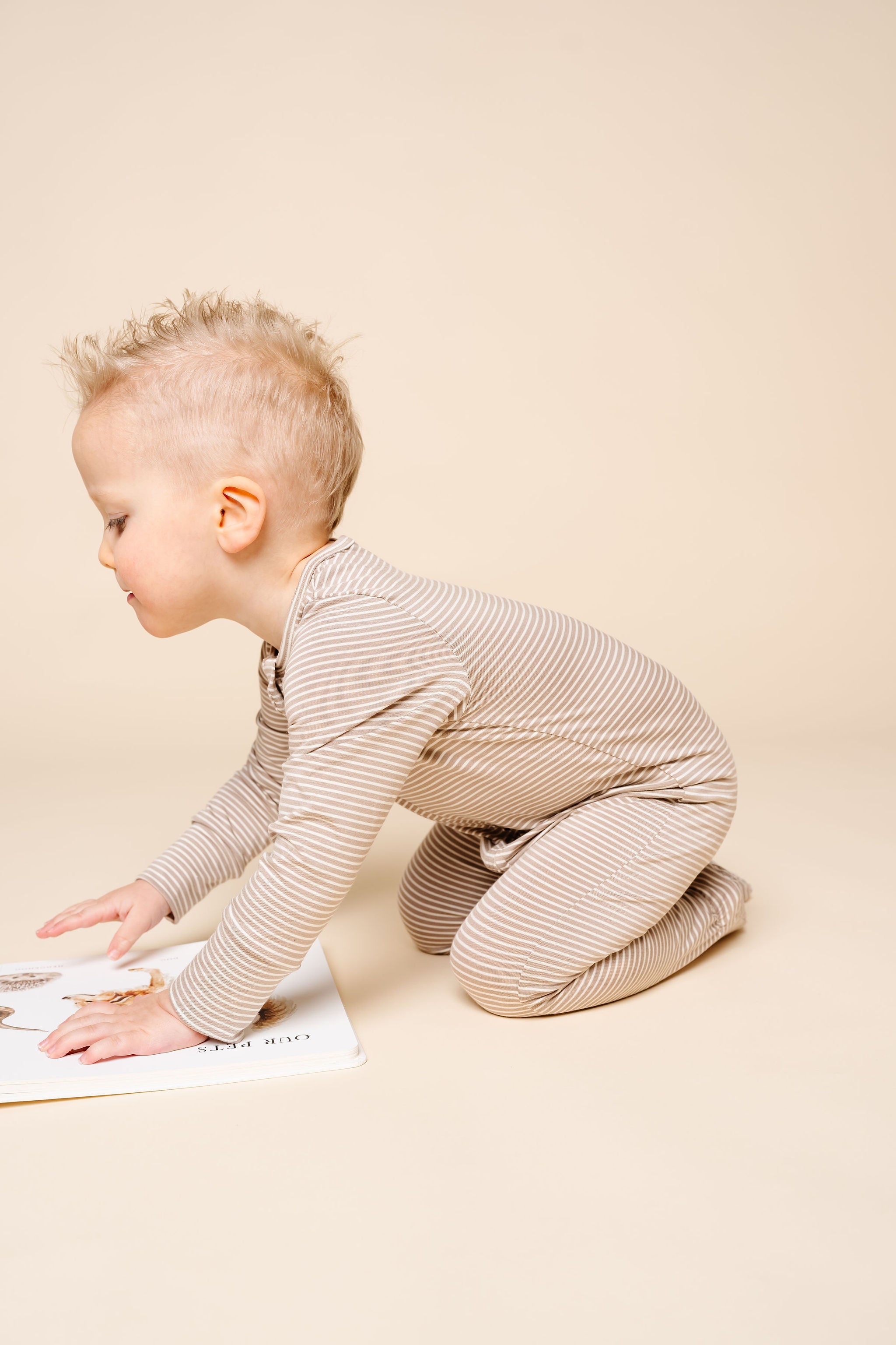 banks toddler boy zipper footies playing on the ground