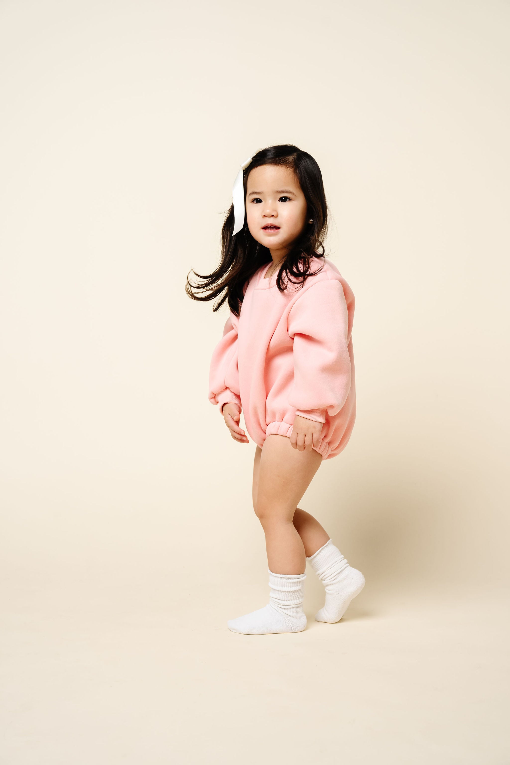 bubblegum sweatshirt romper toddler girl standing dark hair