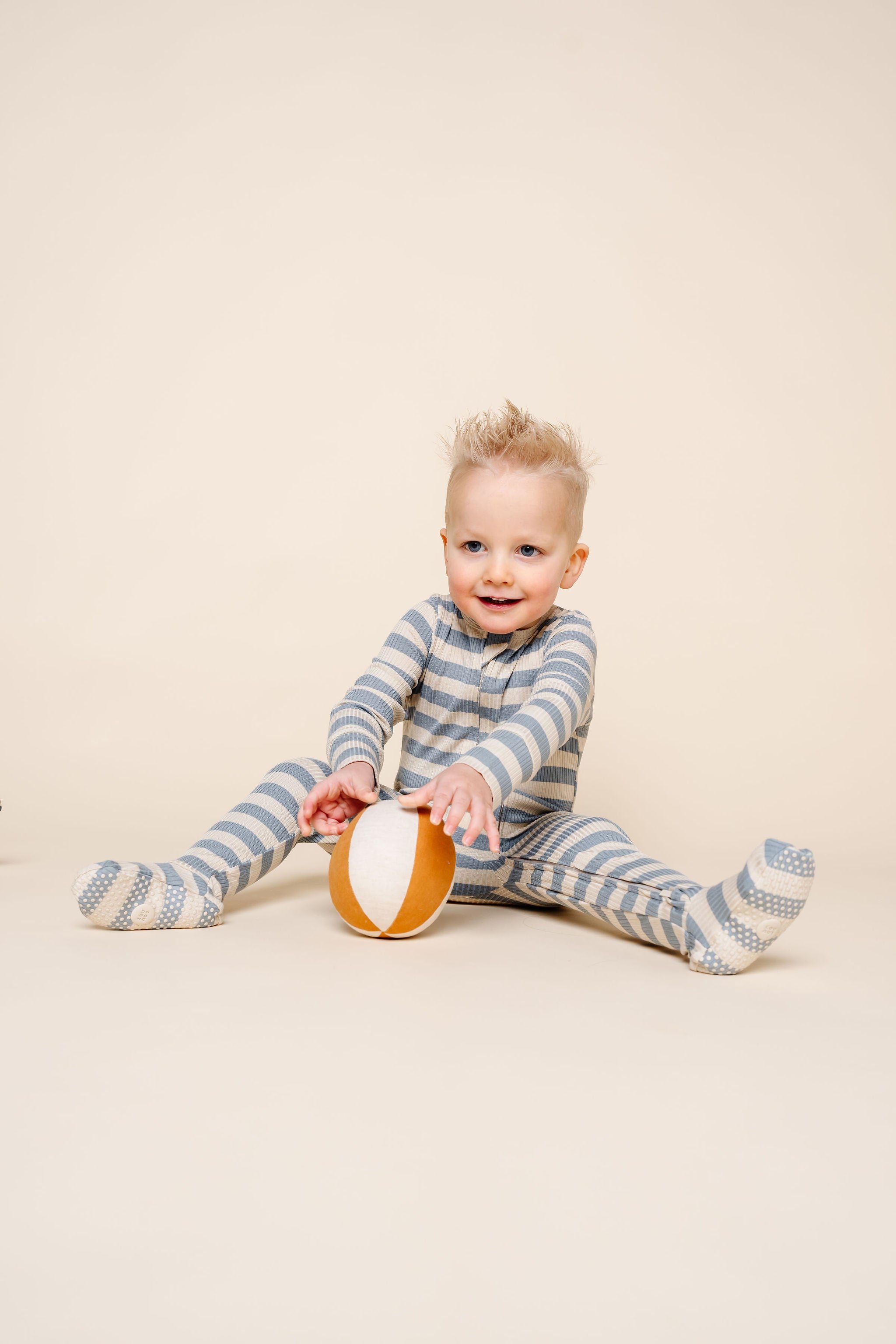 lincoln zipper footies toddler boy playing with ball