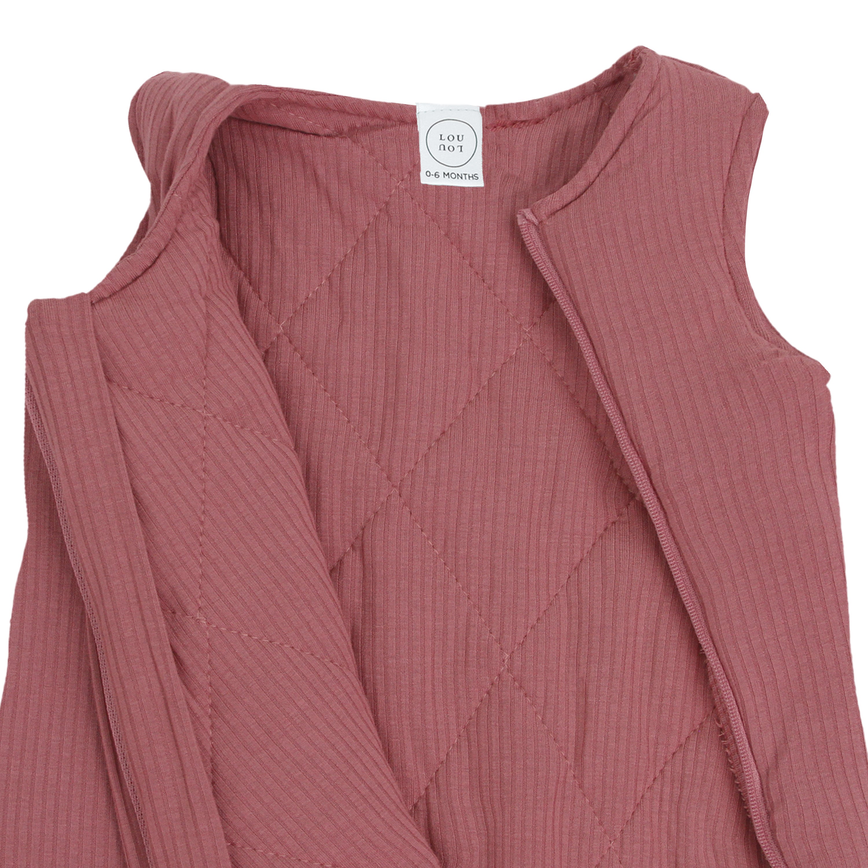 Pink ribbed baby dress with a brand label on a white background