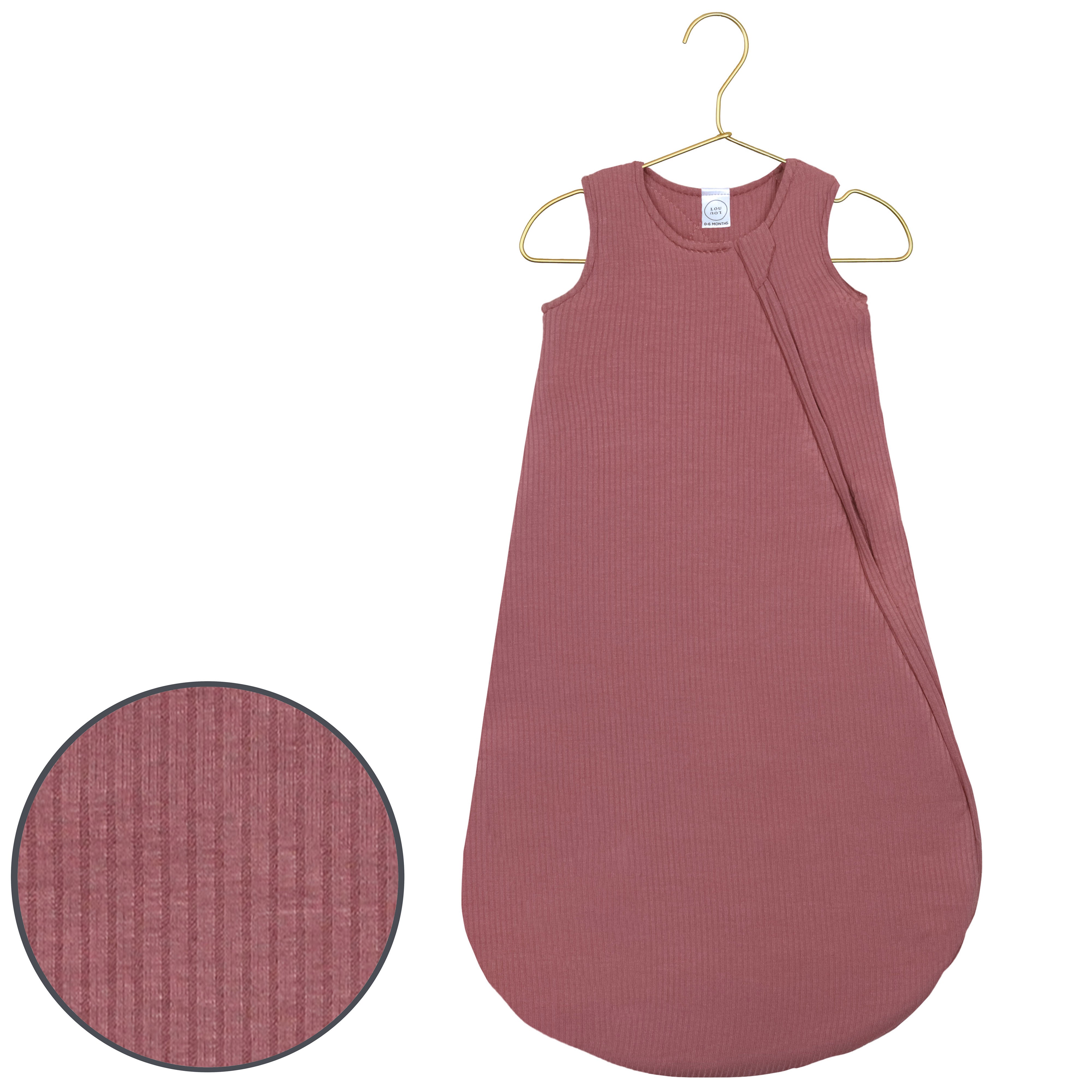 Pink baby sleeping bag with a close-up of texture on a white background
