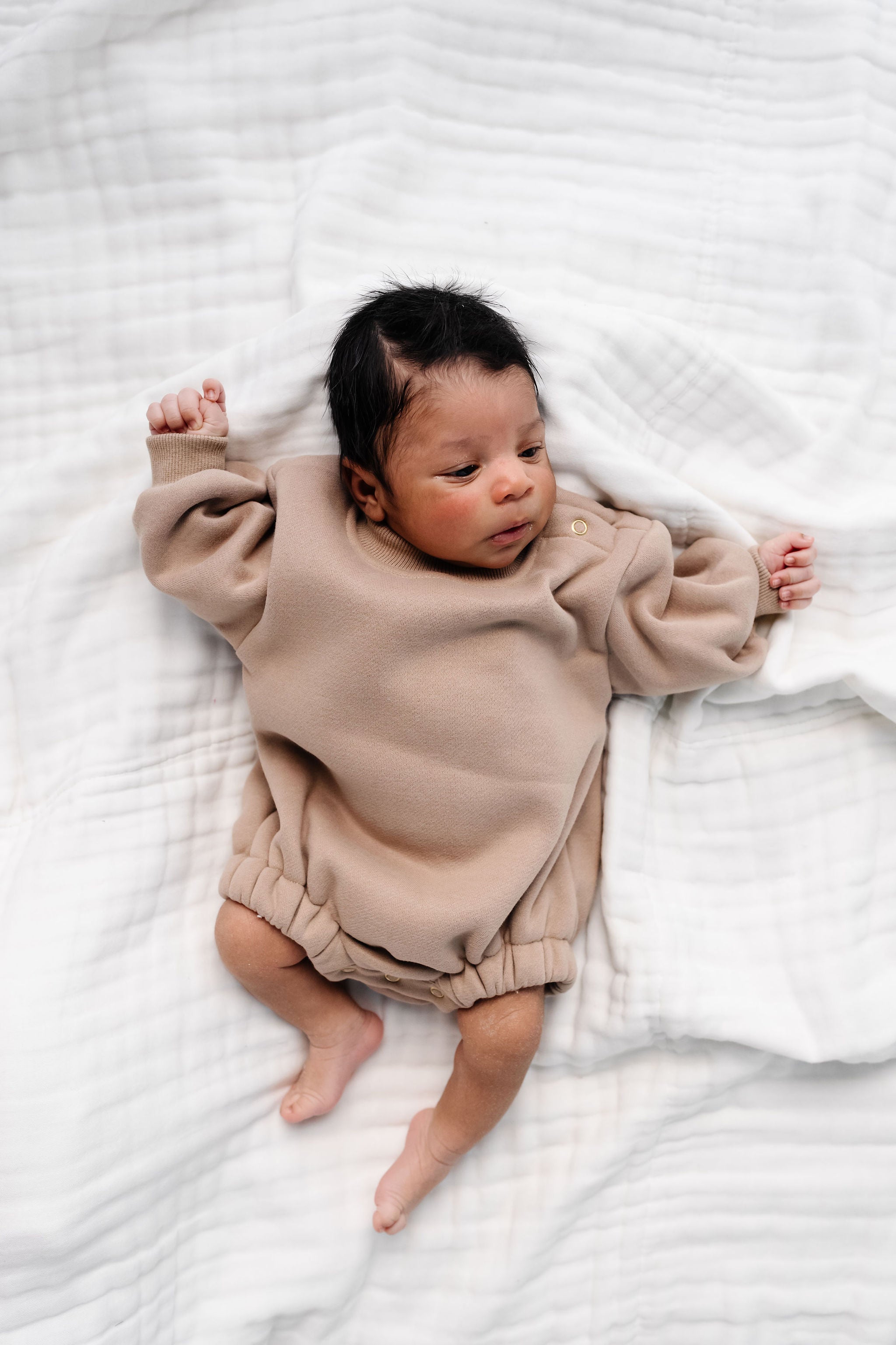 mocha sweatshirt romper baby boy laying on bed