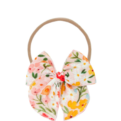 Floral bow hair tie on a white background