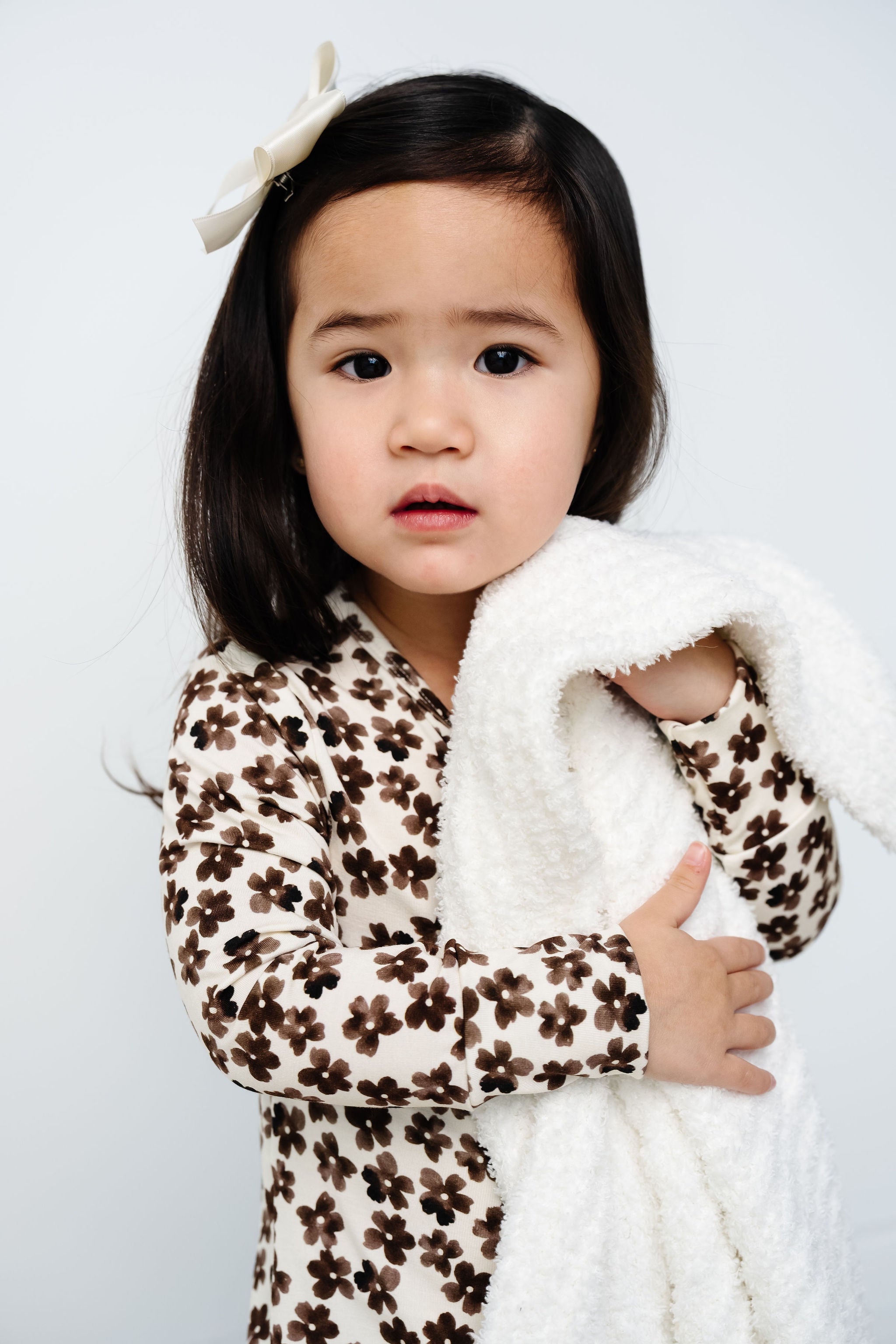 sloane zipper footies toddler girl close up on fabric holding white chenille