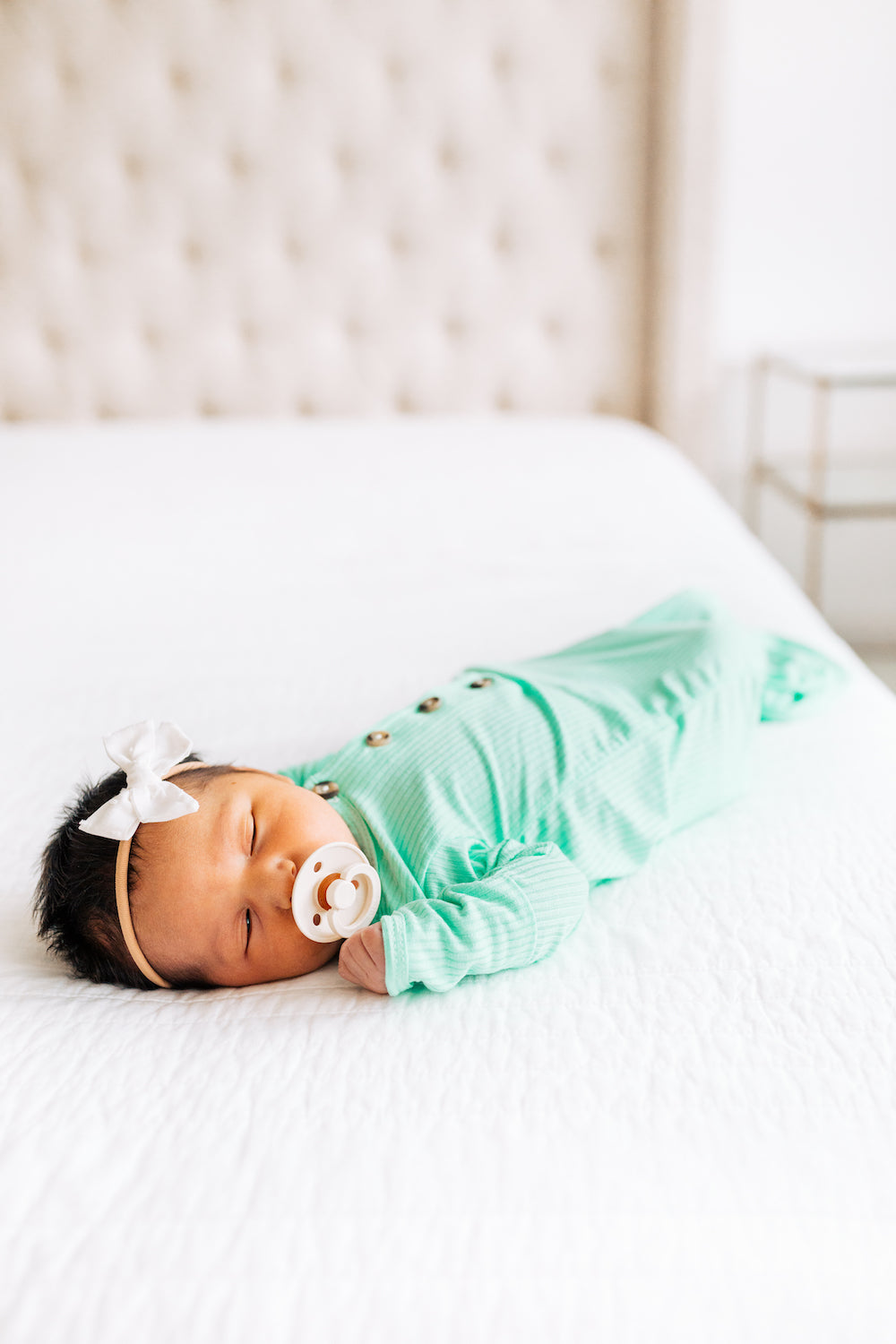 scotty knotted gown newborn girl laying on bed sleeping