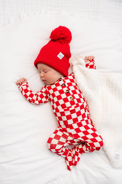 Baby wearing Rudy top + bottom and red beanie