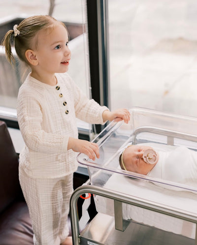 Big Toddler Sister in Cream Play Set with baby sister in hospital basket with a finley swaddle. 