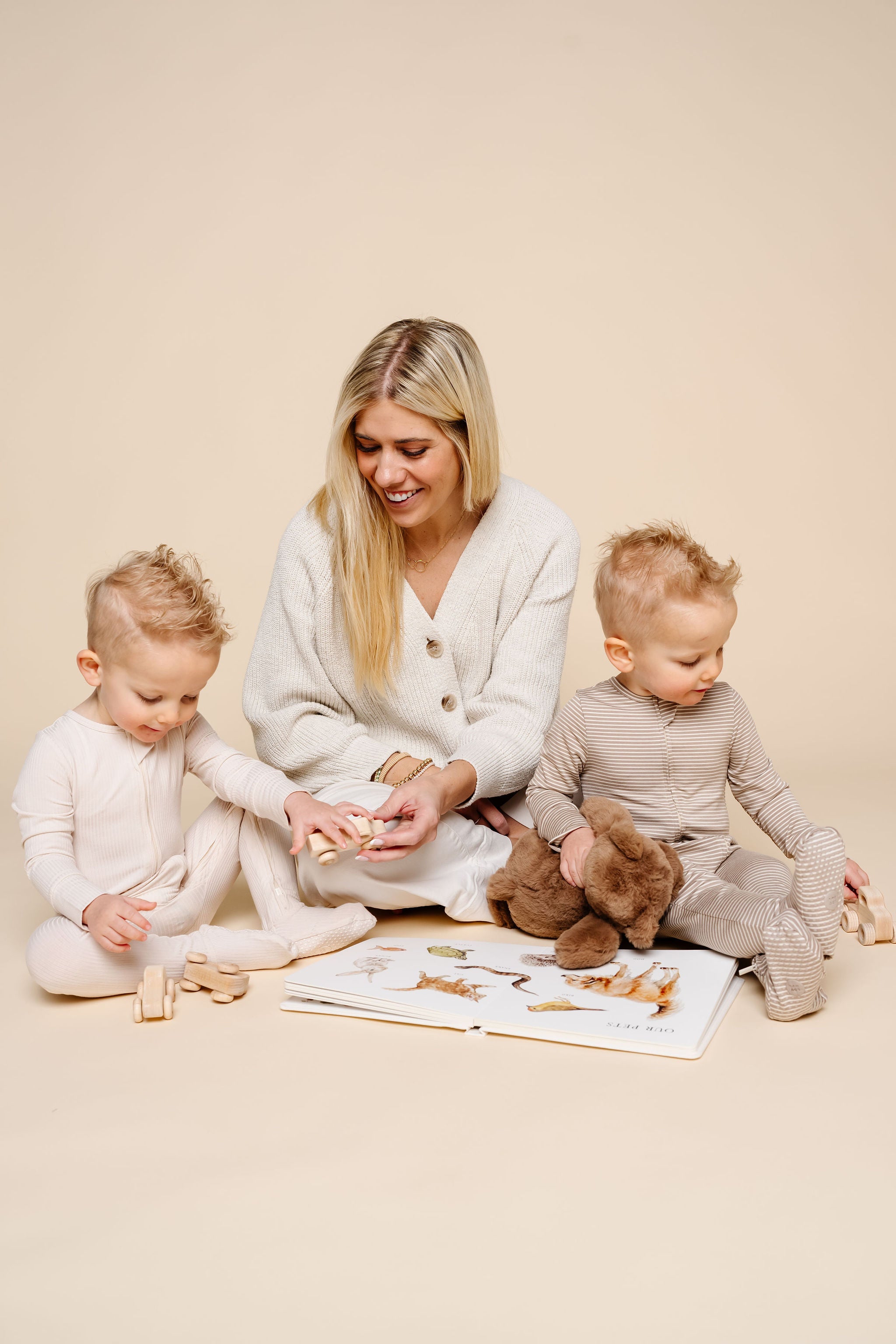 banks and cove zipper footies sitting on ground playing with karen toddler boys twins. 