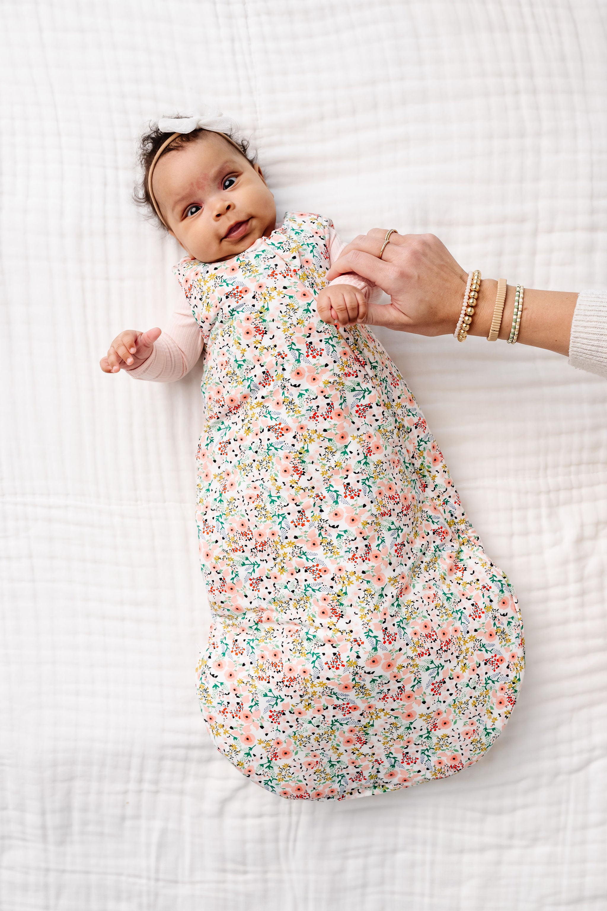 millie sleep sack newborn laying on bed