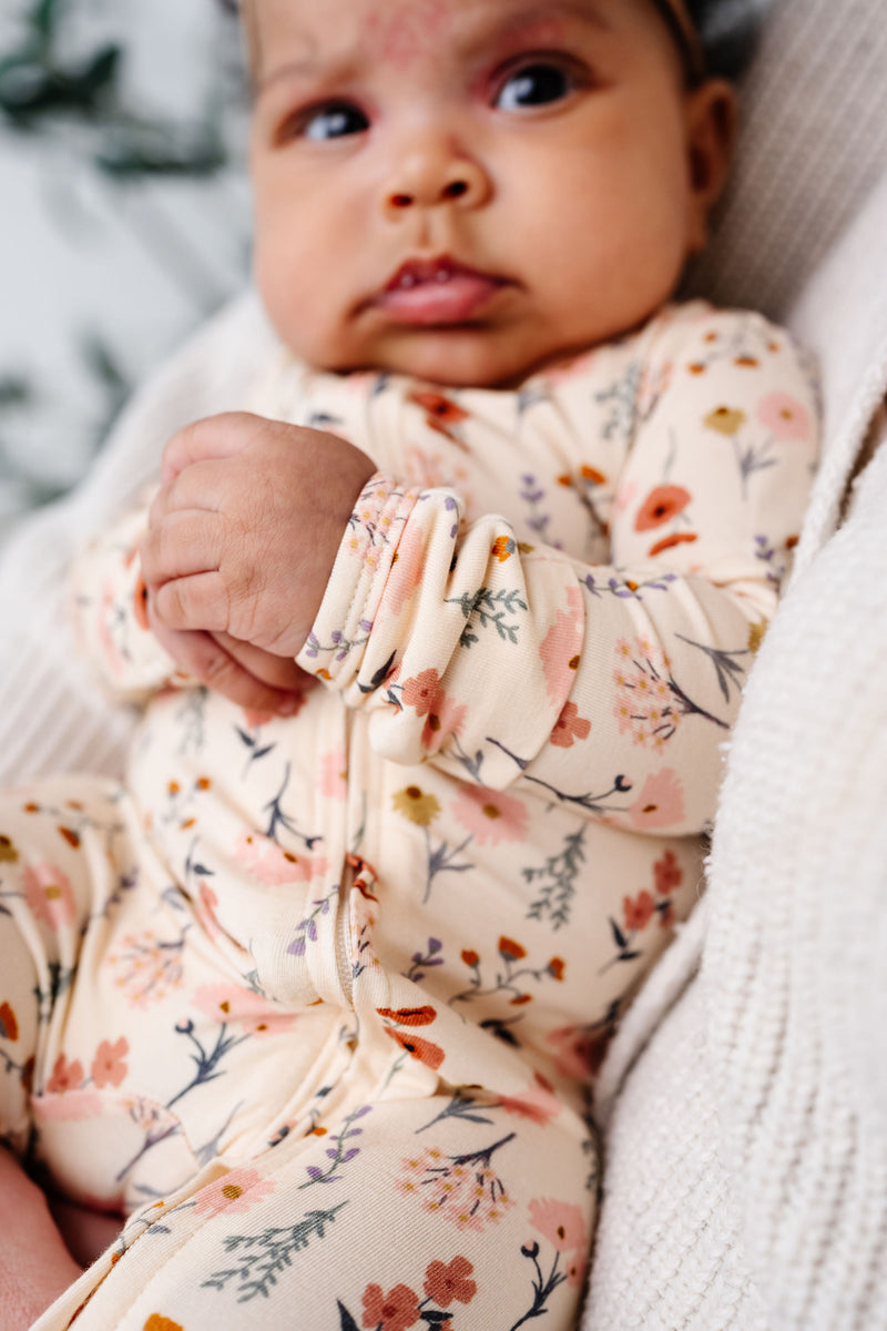 rachel zipper footies close up on print and zipper. 