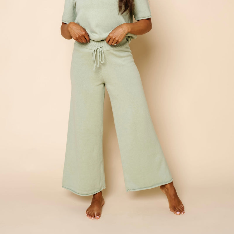 Women wearing Sage Knit Short Sleeve Tee & Wide Leg Pants. Wearing size Small close up on just the pants.
