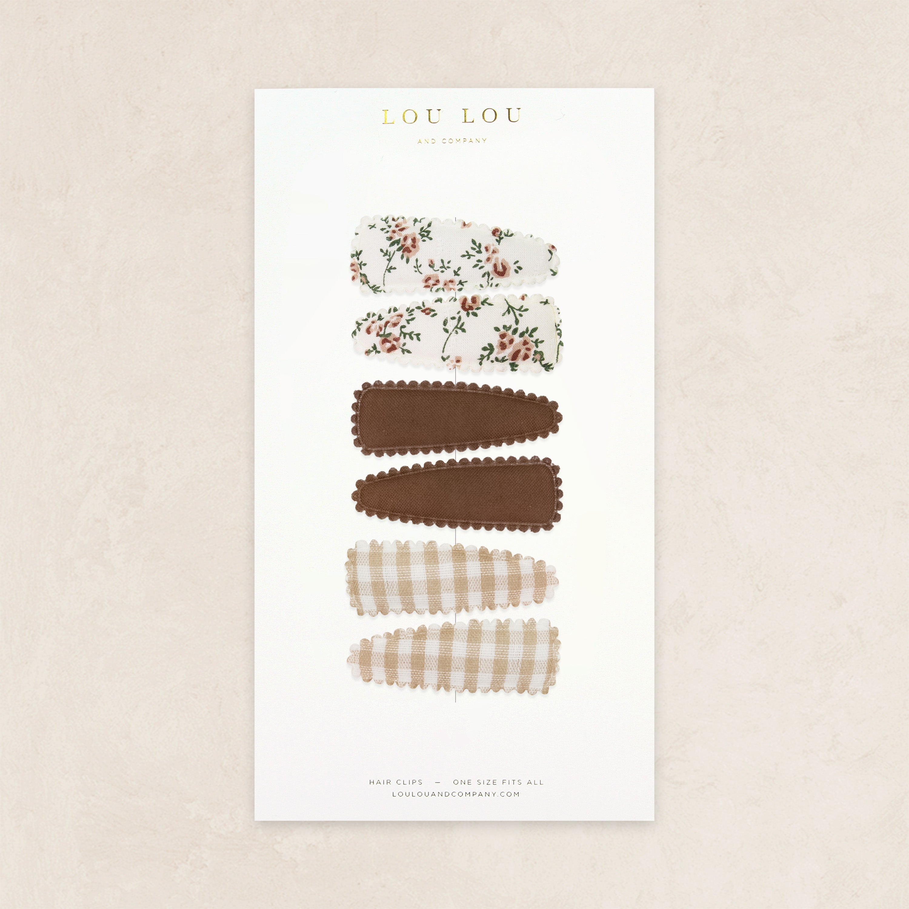 Product display card with hair accessories on a beige background